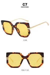Irregular tortoiseshell sunglasses with yellow lenses and slim gold temples, front side view.