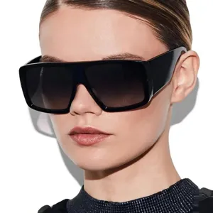 Close-up of model wearing stylish oversized square black sunglasses with UV protection.
