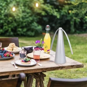 Outdoor tabletop automatic fly fan detail view, silver cone base with flexible repeller blades.