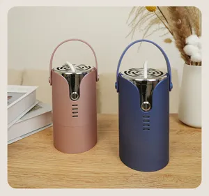 Detailed view of pink and dark blue portable mini clothes dryers on a natural wooden table