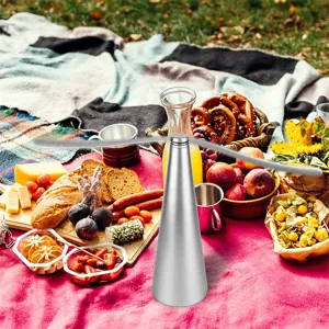 Close-up detail of silver automatic fly repellent fan on outdoor picnic table setup.