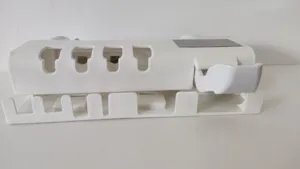Detail view showing the solar panel and toothbrush slots of the wall-mounted sanitizer