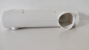 Detailed macro view of the white plastic housing for automatic toothpaste dispenser