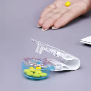 Close-up of a portable white and blue pill taker tool with stored yellow medicine tablets