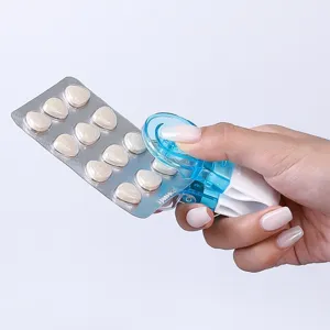 Portable pill popper tool for easy tablet removal from blister packs for home use.