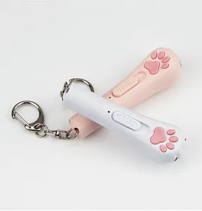 Close-up detail of the cute cat paw mini laser cat toy with key ring and USB charging port.
