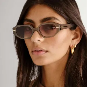 Detailed view of fashionable irregular small-frame sunglasses worn by a model