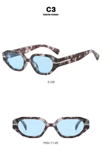 Detail view of irregular small frame sunglasses with blue lenses and marble pattern