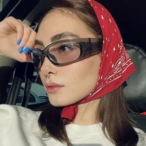 Stylish Y2K wrap-around sport sunglasses with grey lenses worn by model for detail.