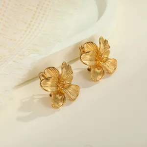 Close-up of vintage gold plated 3D flower stud earrings showing fine petal textures