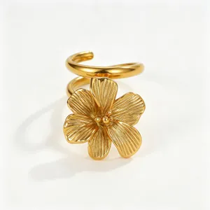 Close-up of vintage gold-plated stainless steel flower earring with textured petals