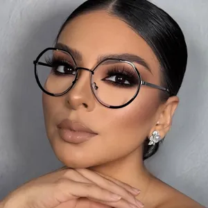 Close-up portrait of a model wearing oversized black polygonal blue light glasses frames