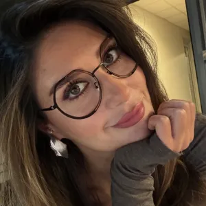 Close-up of stylish round large frame glasses with anti-blue light lenses on model