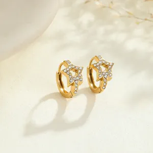 Detailed macro view of gold-plated star hoop earrings inlaid with sparkling cubic zirconia