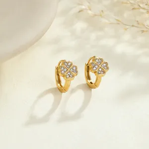 Close-up of gold-plated clover hoop earrings with sparkling crystal pave setting
