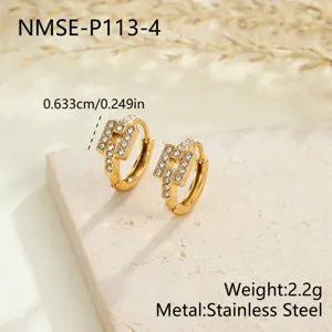 Close-up detail of gold stainless steel hoop earrings with crystal paved geometric charms.