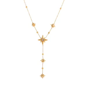 Detailed view of the gold-plated starburst charms with center crystals on the necklace.