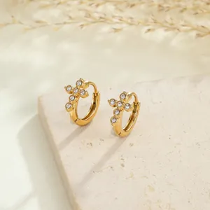 Close-up of gold-plated stainless steel cross hoop earrings with sparkly cubic zirconia