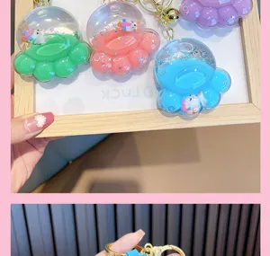 Colorful acrylic bear paw floating quicksand keychains featuring tiny unicorn charms inside.
