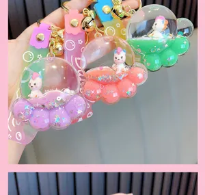 Close-up detail of the floating liquid, glitter stars, and unicorn in the bear paw keychain