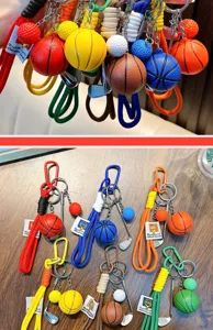 Detailed view of colorful basketball and golf themed keychains laid on wooden surface
