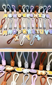 Detailed view of colorful PU leather alphabet keychains with stylish stitched edges.