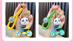Detailed view of yellow and green cartoon panda riding bike PVC keychains