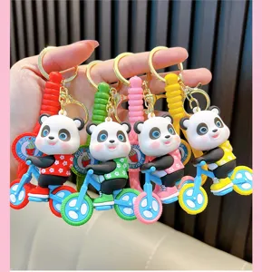 Close-up of cute PVC cartoon panda on bicycle keychains in multiple vibrant colors