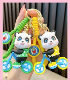 Detailed close-up of cute 3D cartoon panda riding bicycle PVC soft glue keychain charms