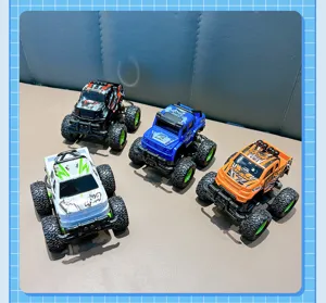 Detailed view of four colorful mini monster truck pull-back car keychains for kids