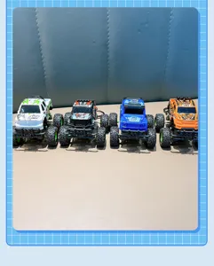 A detailed view showing four different colors of pull-back off-road monster truck keychains
