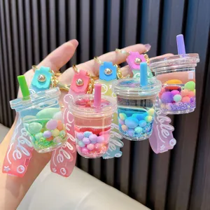Colorful liquid bubble tea cup keychains with sugar bean quicksand and silicone strap.