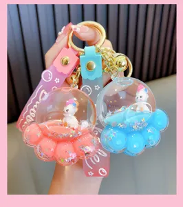 Macro view of cute acrylic cat paw keychains with floating unicorn figures and colorful liquid