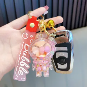 Schattige lichtgevende astronaut sleutelhanger met roze vloeibaar zand