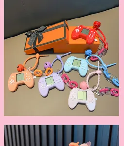 Vibrant collection of retro mini Tetris controller keychains displayed with orange gift boxes