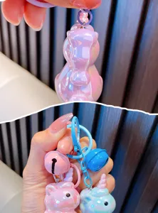 Close-up of cute pearlescent acrylic unicorn keychains with colorful bells and clasps