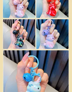 Close-up showing various colors of shiny plated acrylic unicorn keychains with bells