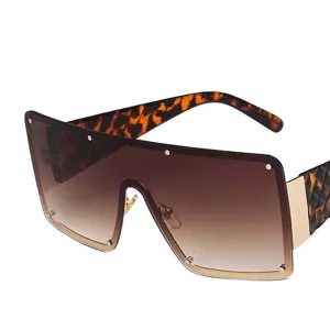 Oversized square tortoiseshell sunglasses with brown gradient lenses and gold rivets