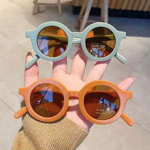 Cute round-frame children's sunglasses featuring light green and orange matte frames