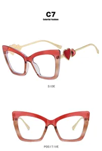 Stylish red cat-eye glasses with heart decorations and anti-blue light lens technology.