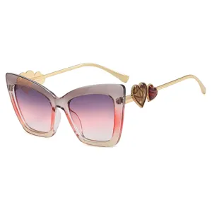 Fashionable cat-eye glasses frame with heart detail and gradient lenses.