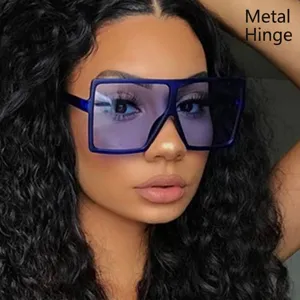 Retro oversized square sunglasses with blue frame and metal hinges on model