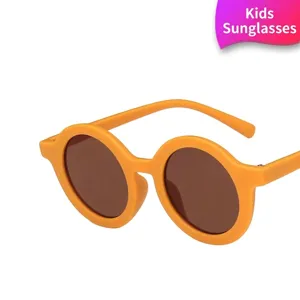 Stylish round yellow sunglasses for children featuring dark lenses and matte frame