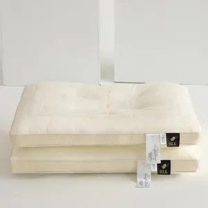 Detailed view of the 3D embroidery on premium Tencel latex pillows with silk brand tags