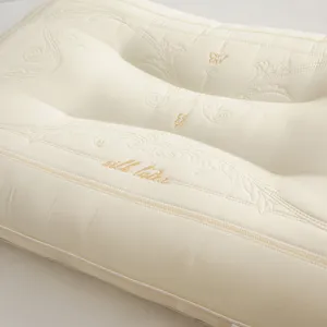 Close-up of premium Tencel latex pillow with elegant gold butterfly embroidery detail
