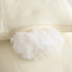 Detailed macro view showing the soft white fiber filling of the butterfly latex pillow