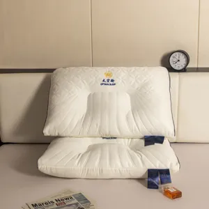 Detailed macro view of ergonomic white cervical pillows with contoured neck support design.
