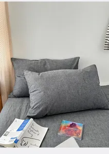 Detailed view of gray washed cotton pillowcases in a minimalist bedroom setting