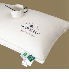 Macro view of a high-quality cotton pillow with embroidered DEEP SLEEP text and tags.