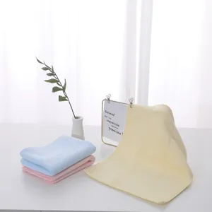 Detailed view of soft latex face towels in pastel pink, blue and yellow